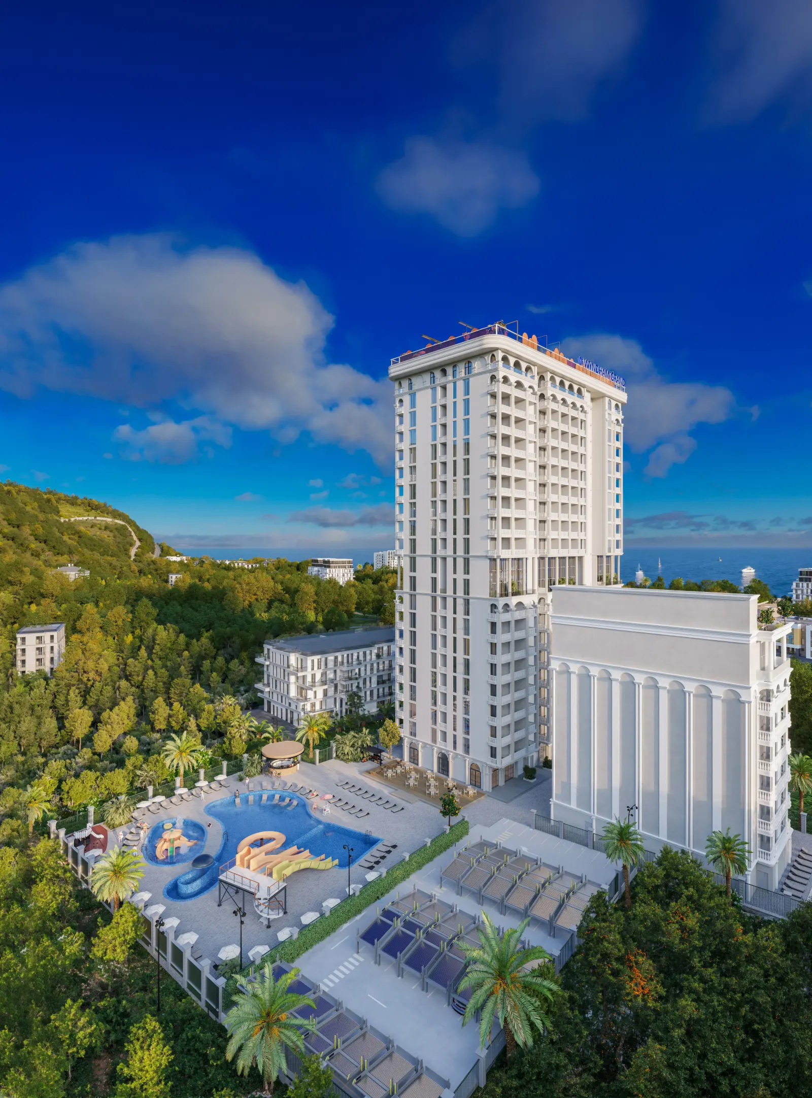 Комплекс Wyndham Grand Batumi Gonio: башня корпуса Aqua, аквазона с бассейном и горками, зелень и море на горизонте